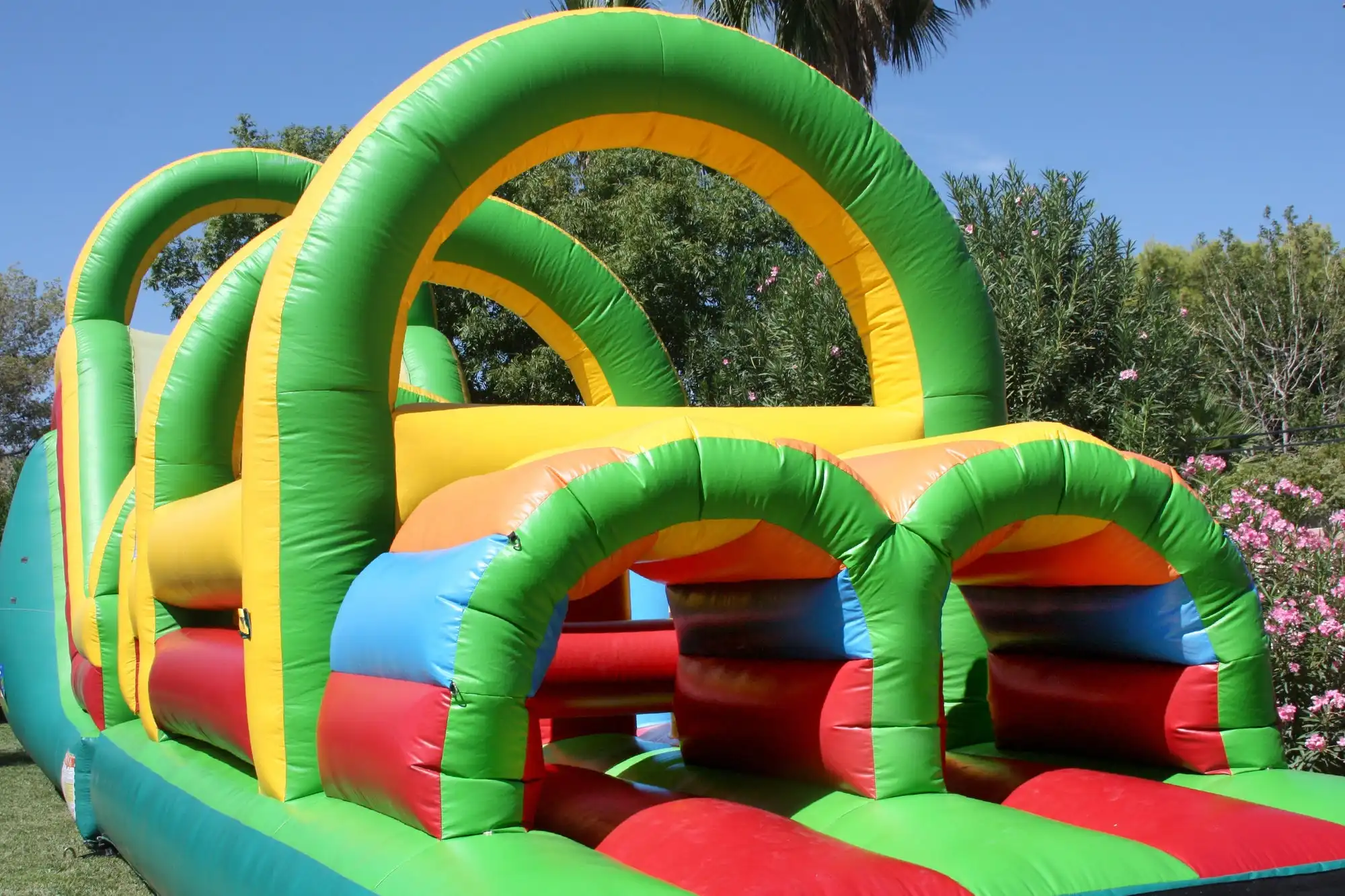 Bounce house cleaning process showing a clean colorful inflatable obstacle course